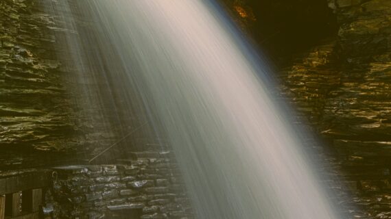 A close-up image of a waterfall in long exposure photography. Vintage style processing.