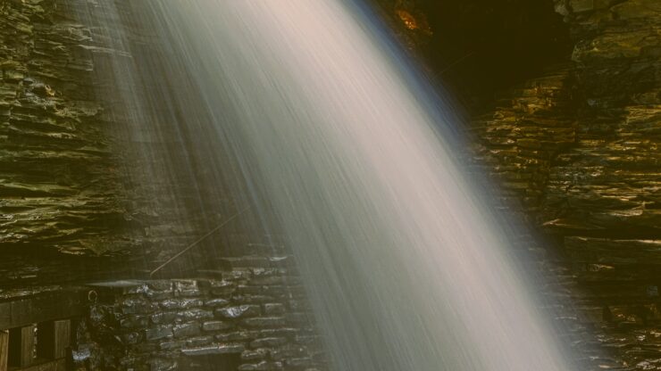 A close-up image of a waterfall in long exposure photography. Vintage style processing.